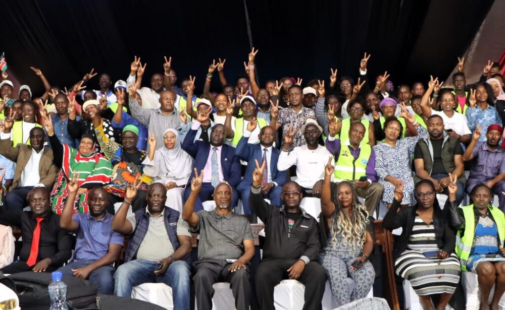 Participants at International Peace Day 2025 raise their hands